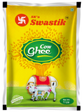 A 1-liter bag of SK's Swastik Cow Ghee, featuring a bright yellow packaging design with a green central label, a red swastik symbol, and an illustration of a decorated cow and calf on a green field background.